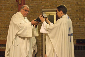 Fr. Charles recieves the Gospels